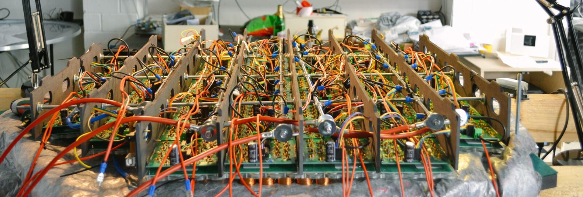 The electromagnet grid rig mid-build, wired boards fanning out around a central ring.