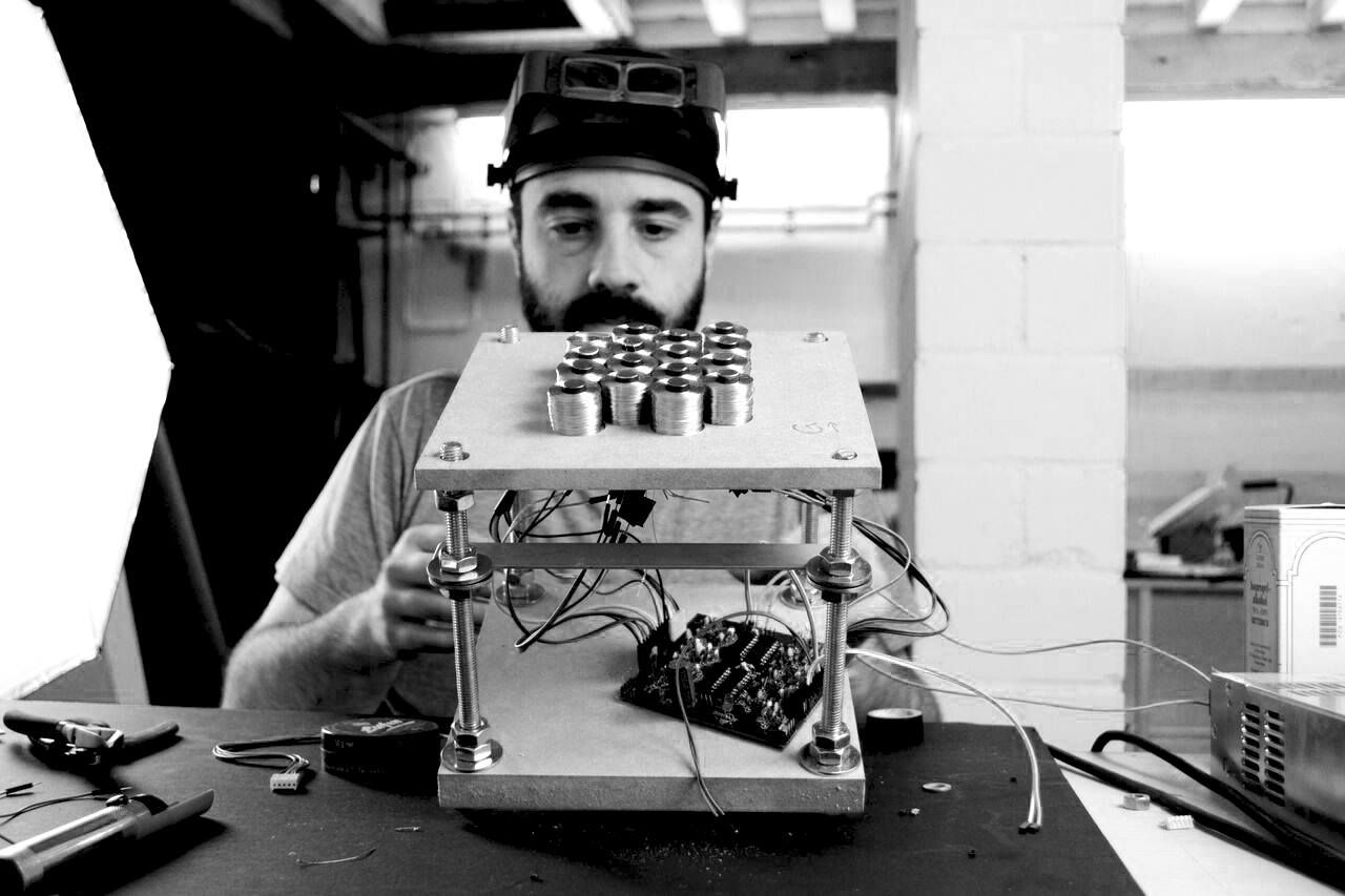 Assembling a bank of wound electromagnets onto its driver board.