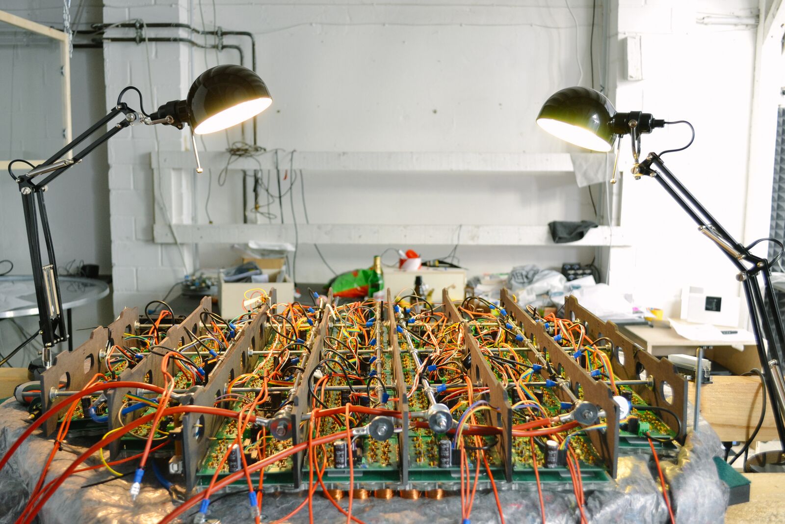 Front view of the finished rig on the workbench, lit by two desk lamps.