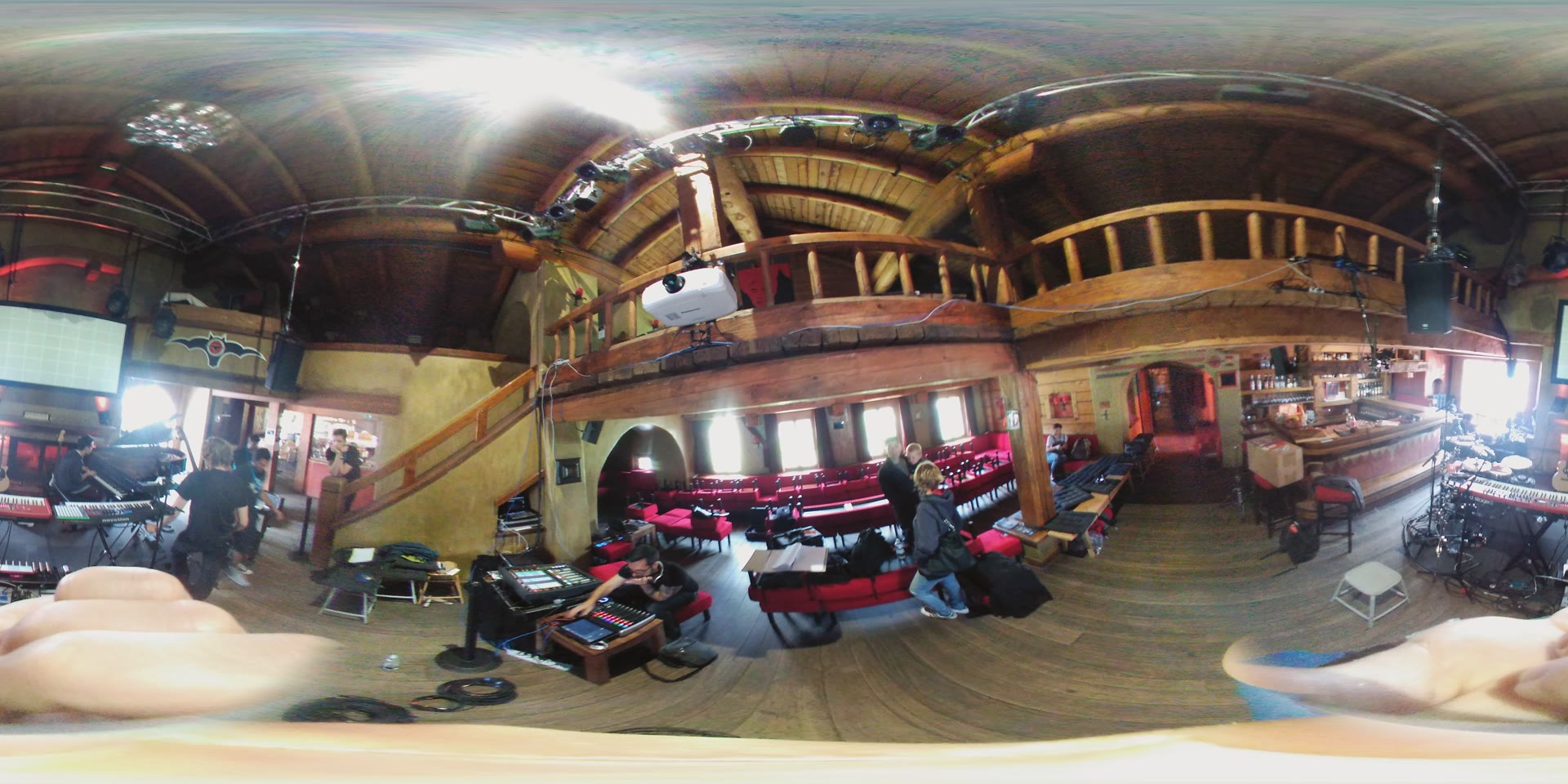 360-degree photo of the venue backstage and gear setup, with a projector mounted on the balcony railing.